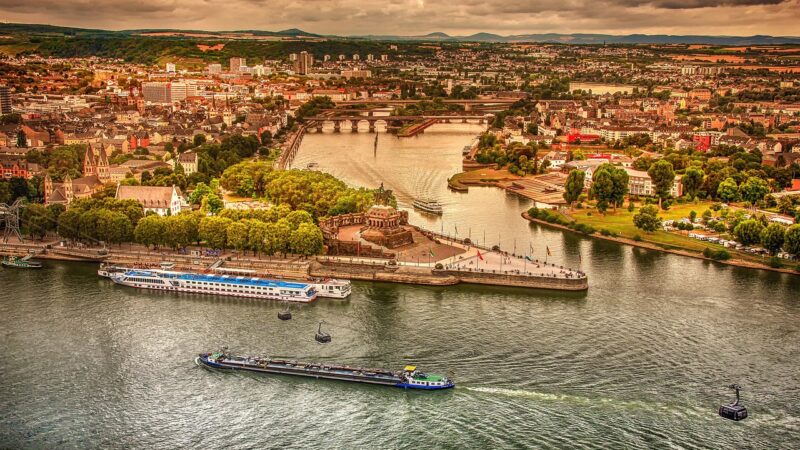 Ein Frachtschiff fährt bei Niedrigwasser am Rhein über einen Fluss mit deutlich sichtbarem, abgesenktem Wasserstand – Foto: analogicus / Pixabay
