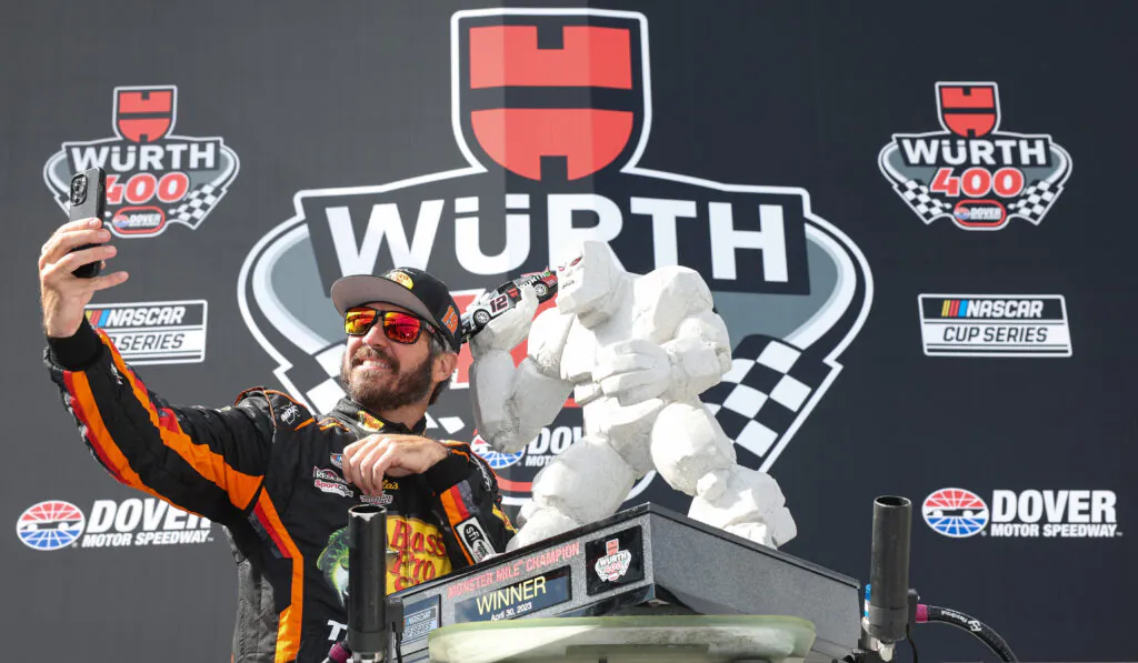 Würth-Logo in Groß und in klein. Davor Martin Truex Jr als Gewinner der NASCAR Cup Series Würth 400
